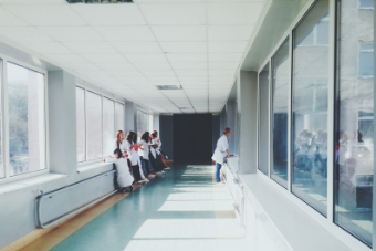 people standing in a hospital corridor